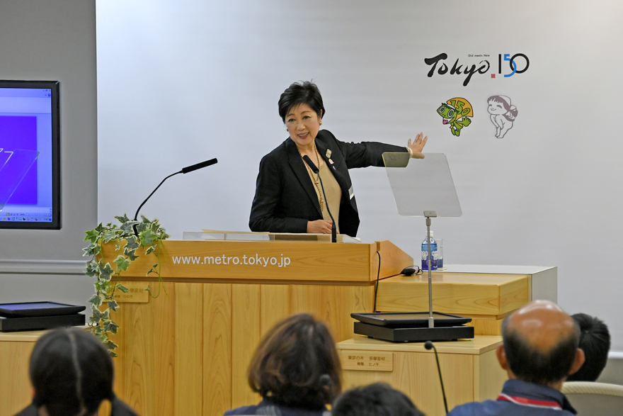 Photograph of Governor Koike making a surprise appearance and speaking to tour participants