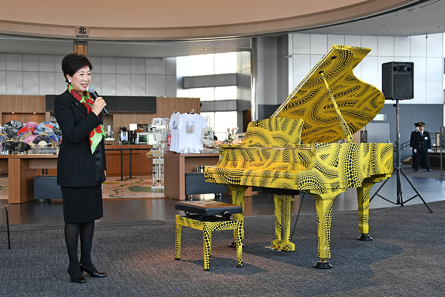 A photo of the governor standing by the piano at the unveiling ceremony