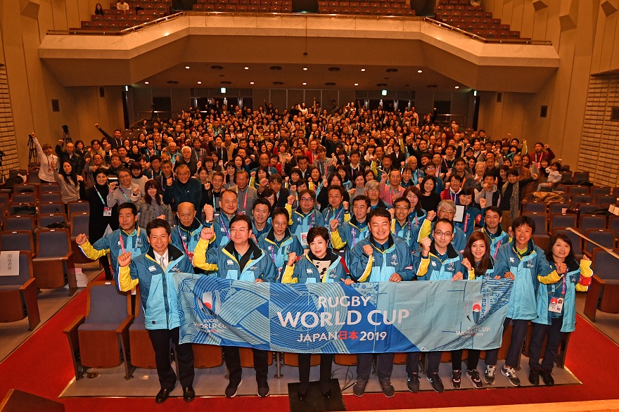  Image of many volunteers and a Rugby World Cup banner